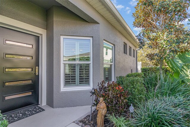 property entrance with stucco siding