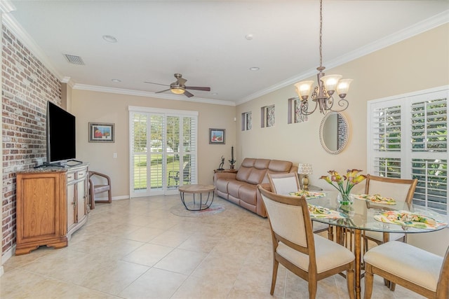 dining room featuring visible vents, crown molding, and brick wall