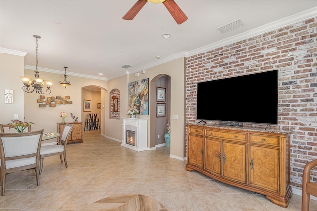 living room with light tile patterned floors, visible vents, a ceiling fan, a glass covered fireplace, and ornamental molding