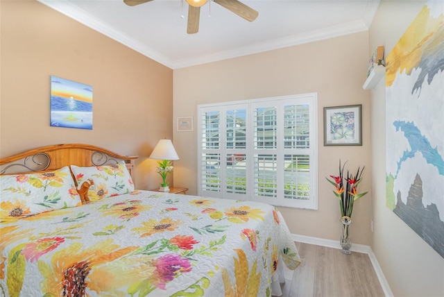 bedroom featuring baseboards, ceiling fan, wood finished floors, and crown molding