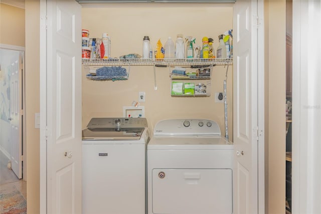 clothes washing area with laundry area and washing machine and clothes dryer