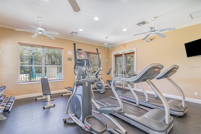 exercise room featuring a textured ceiling, crown molding, and baseboards