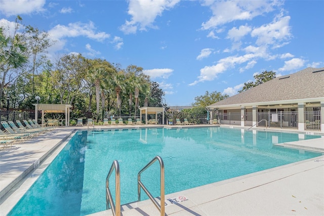 pool featuring fence and a patio