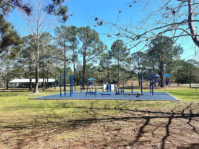 view of property's community with playground community and a lawn