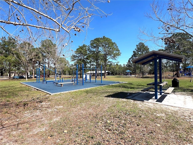 view of home's community with playground community and a yard