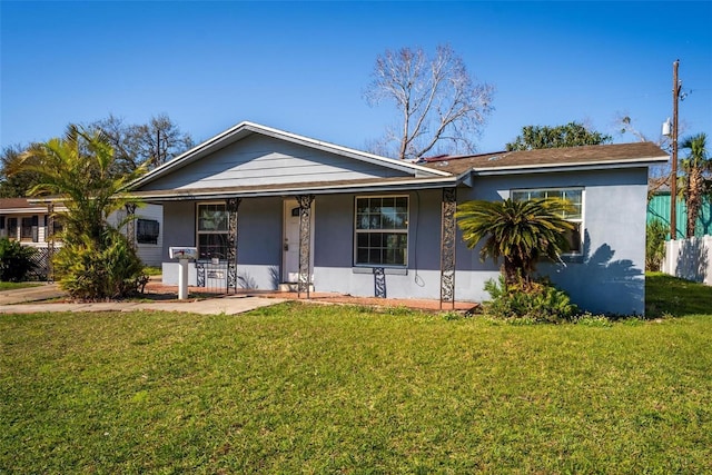 view of front facade with covered porch and a front yard