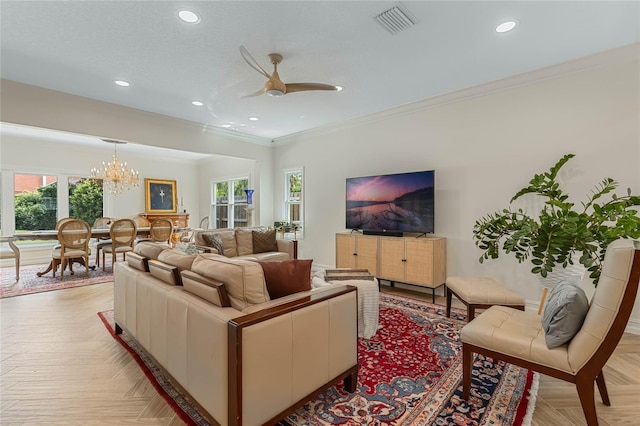 living room featuring light parquet flooring, ceiling fan with notable chandelier, a textured ceiling, and crown molding