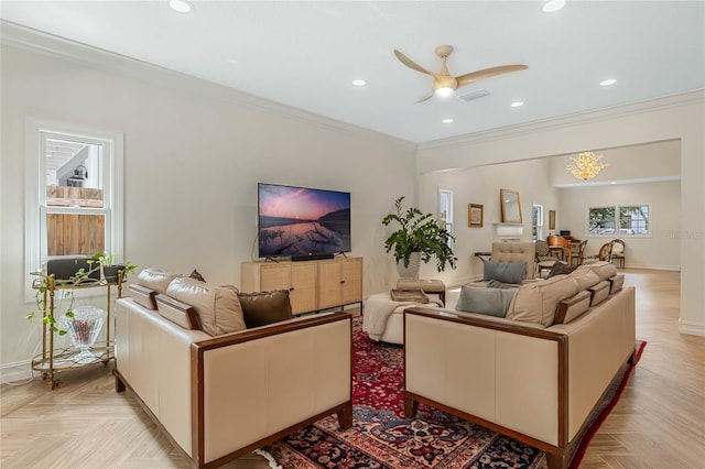 living room featuring ceiling fan, ornamental molding, and light parquet flooring