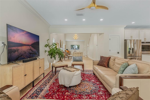 living room with crown molding, light wood-type flooring, and ceiling fan