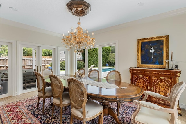 dining room featuring an inviting chandelier and crown molding