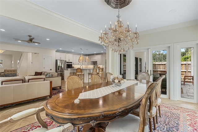 dining space with crown molding, ceiling fan with notable chandelier, and light parquet flooring