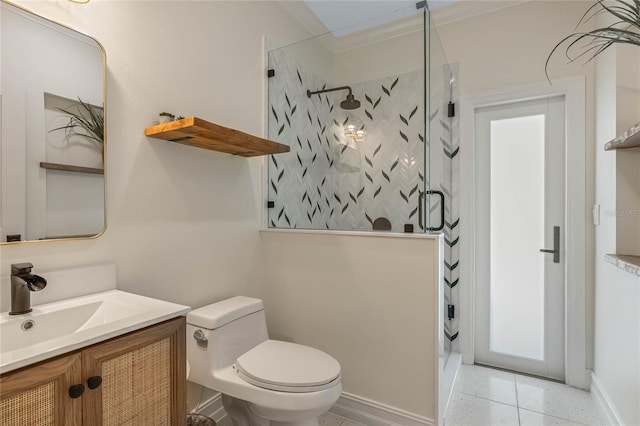 bathroom featuring a tile shower, vanity, and toilet