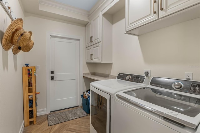 laundry area with washer and clothes dryer, ornamental molding, cabinets, and light parquet floors