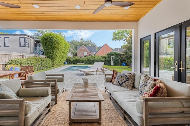 view of patio featuring an outdoor living space, a fenced in pool, and ceiling fan