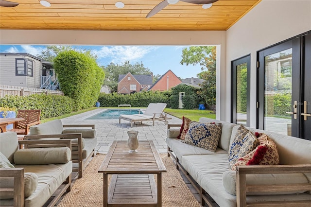 view of patio featuring a fenced in pool, outdoor lounge area, and ceiling fan