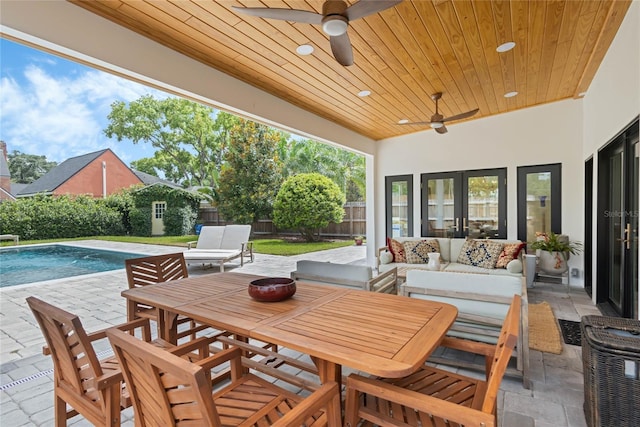 view of patio / terrace featuring ceiling fan, an outdoor hangout area, and a fenced in pool