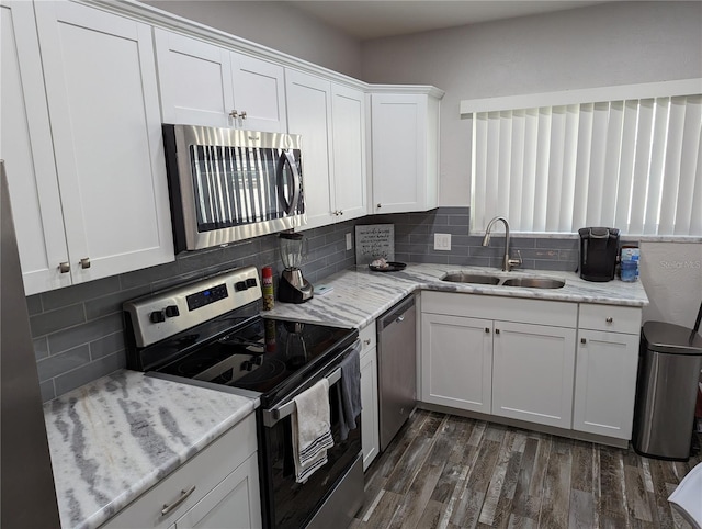 kitchen featuring white cabinetry, sink, decorative backsplash, and appliances with stainless steel finishes