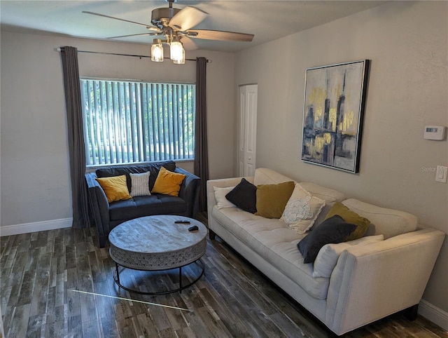 living room featuring dark hardwood / wood-style flooring and ceiling fan