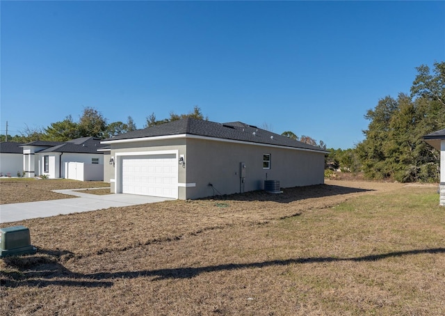 view of property exterior with a garage, a lawn, and central air condition unit