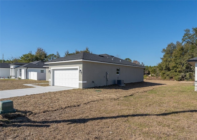 view of home's exterior featuring a lawn, stucco siding, central AC unit, an attached garage, and driveway