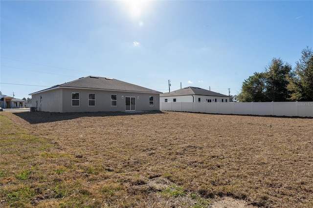 back of house with fence