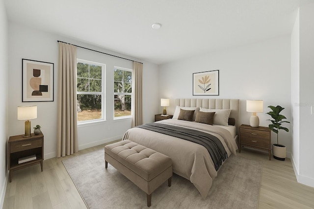 bedroom with baseboards and light wood-style floors