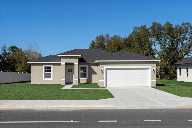 view of front of home with stucco siding, concrete driveway, a front yard, and a garage