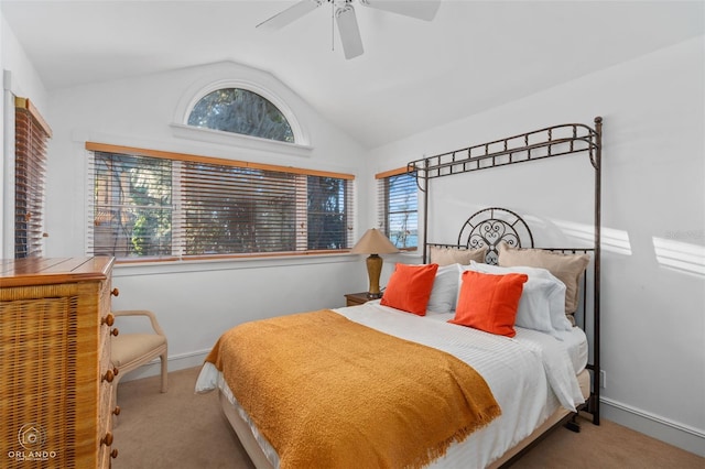 bedroom with ceiling fan, light colored carpet, and vaulted ceiling