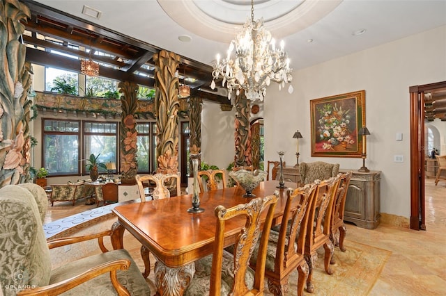 dining room with a notable chandelier and a tray ceiling