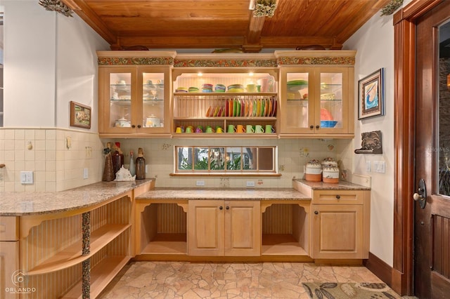 interior space featuring tasteful backsplash, wood ceiling, light stone countertops, light brown cabinets, and beam ceiling