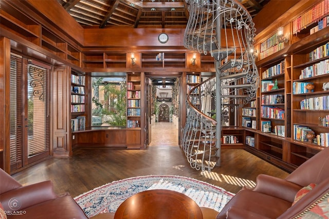 living area featuring hardwood / wood-style flooring and lofted ceiling with beams