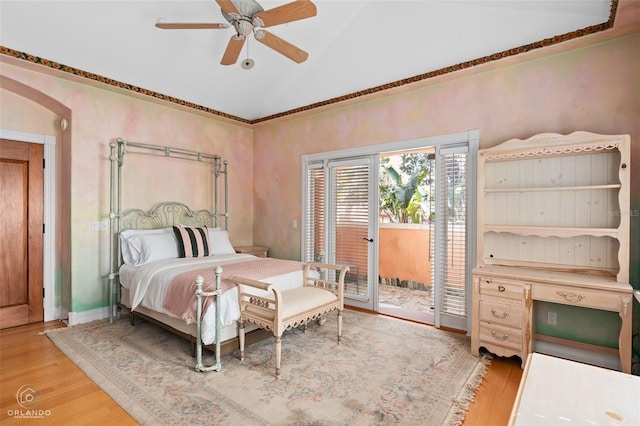 bedroom featuring ceiling fan, wood-type flooring, vaulted ceiling, and access to outside