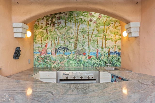 kitchen featuring white cabinetry and stove