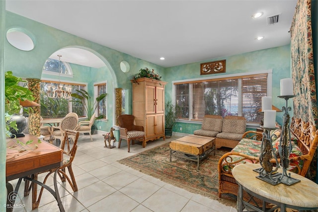 tiled living room with a chandelier