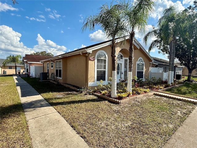 view of front of home featuring a front lawn and central air condition unit