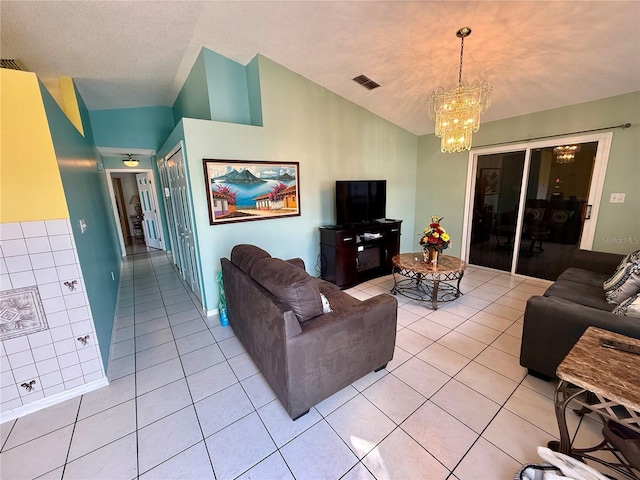 living room featuring lofted ceiling, light tile patterned floors, a notable chandelier, and a textured ceiling