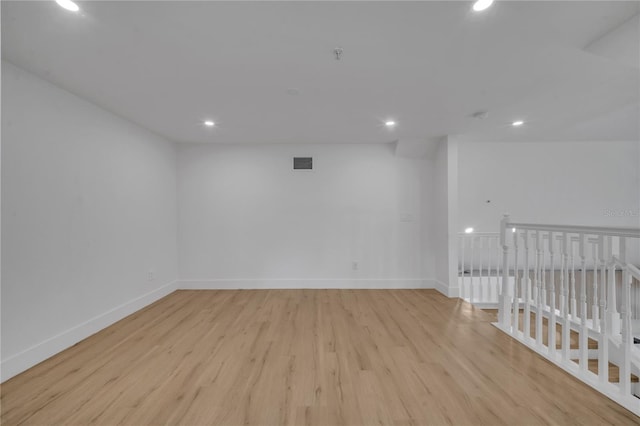 spare room featuring recessed lighting, light wood-type flooring, baseboards, and visible vents