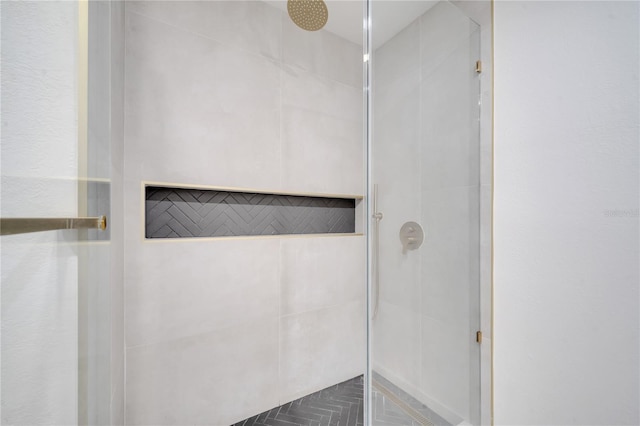 bathroom with a tile shower