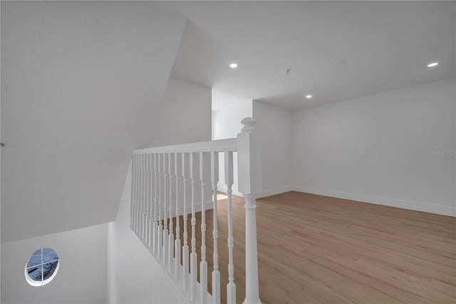 staircase featuring recessed lighting, wood finished floors, and baseboards