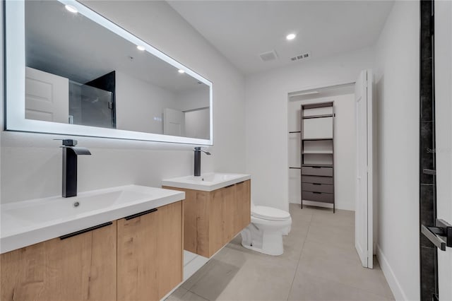 full bath with tile patterned floors, two vanities, visible vents, and a sink