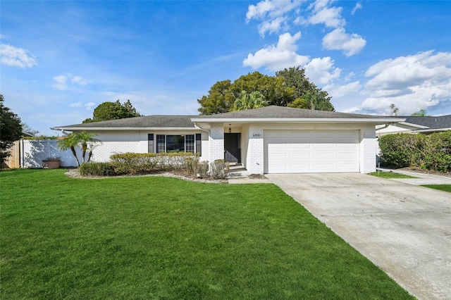 single story home with an attached garage, a front lawn, concrete driveway, and brick siding