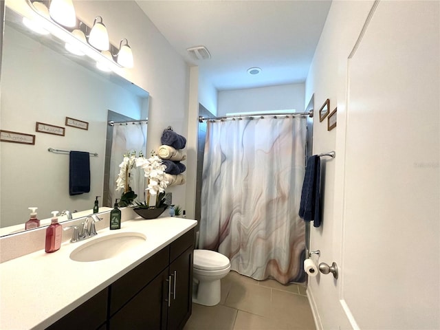 bathroom featuring tile patterned flooring, vanity, and toilet