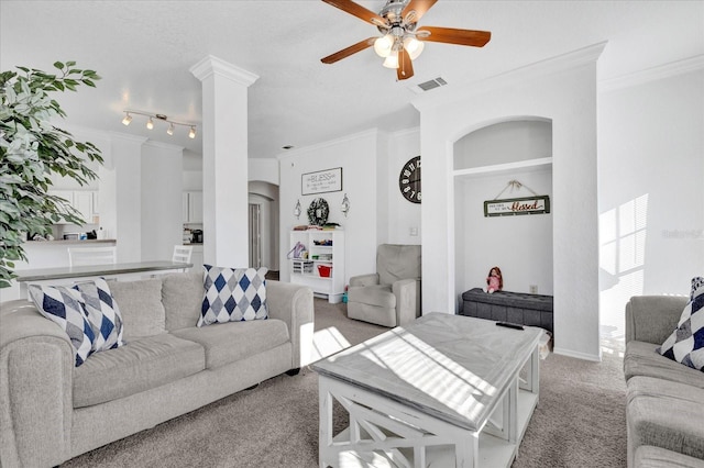 living room featuring ornate columns, ornamental molding, light carpet, and ceiling fan