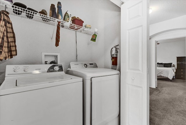 washroom with washer and clothes dryer and carpet