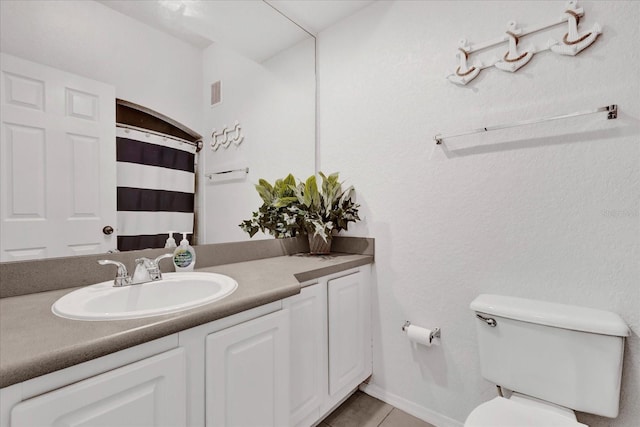 bathroom featuring vanity, tile patterned flooring, a shower with curtain, and toilet
