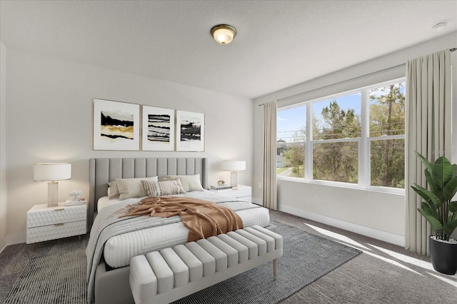 carpeted bedroom featuring a textured ceiling