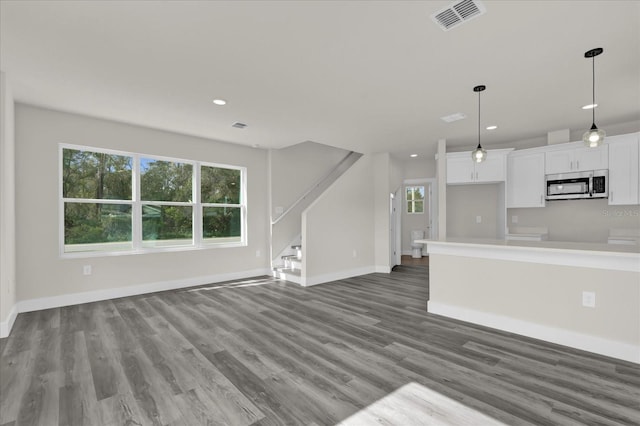 unfurnished living room with wood-type flooring