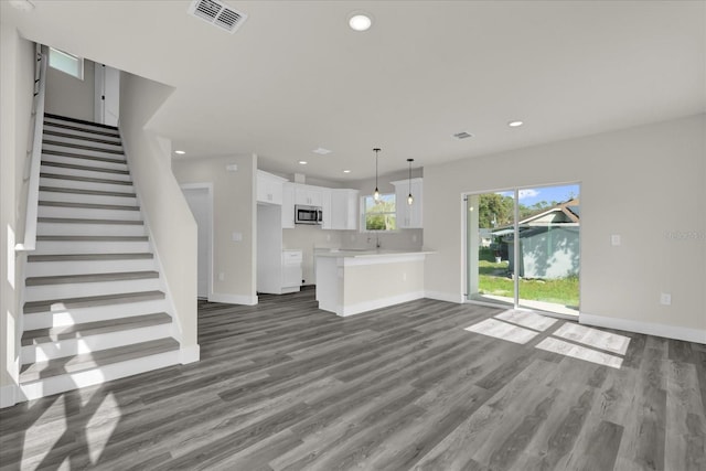 unfurnished living room featuring dark hardwood / wood-style floors