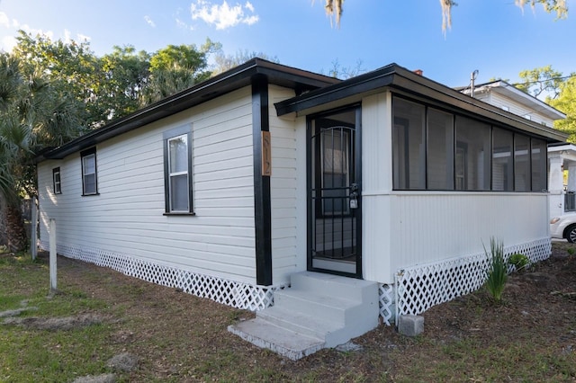 812 S Locust Ave, Sanford, FL 32771 - view of property exterior with entry steps and a sunroom
