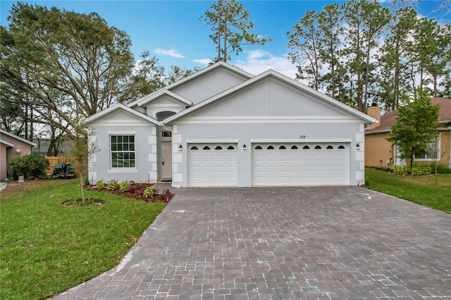 ranch-style home featuring a garage and a front yard